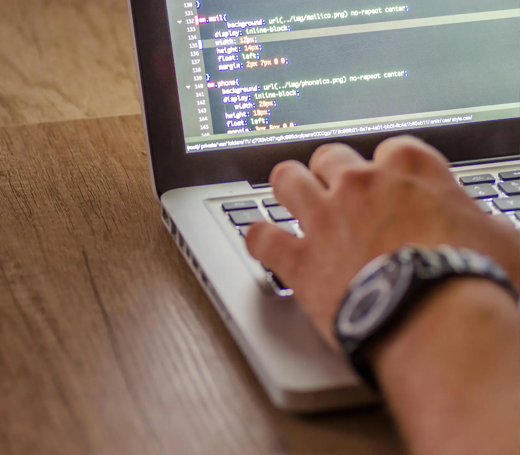 Computer displaying IDE being typed on
