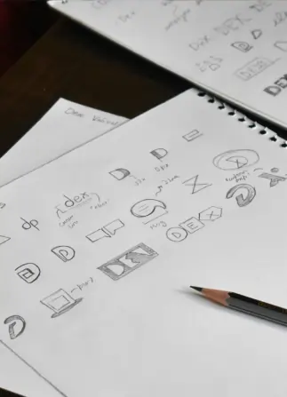 Several logos being sketched in an art book